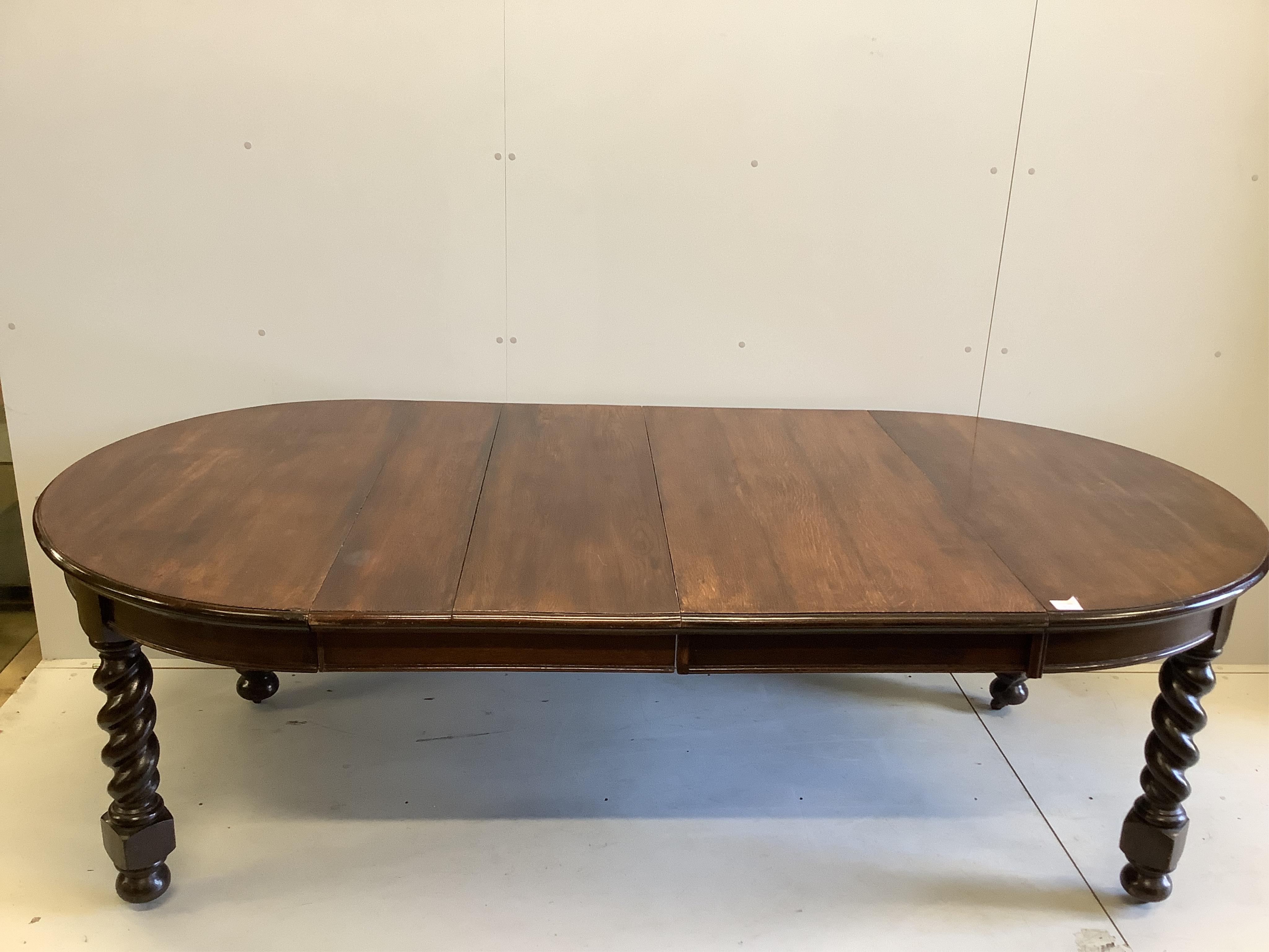 A 1920's oak 'D' end extending dining table, 234cm extended, two spare leaves, depth 120cm, height 74cm. Condition - fair